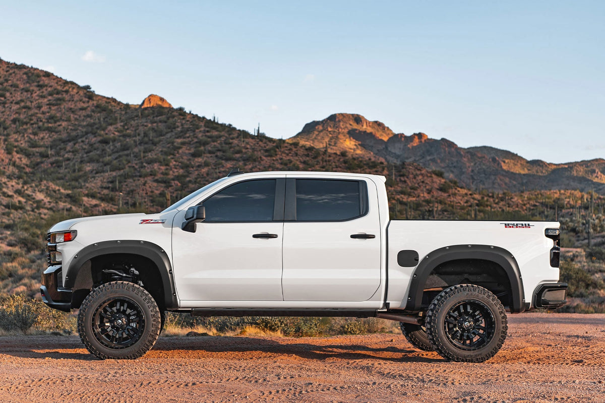 Lifted Chevy Silverado with fender flares in the desert